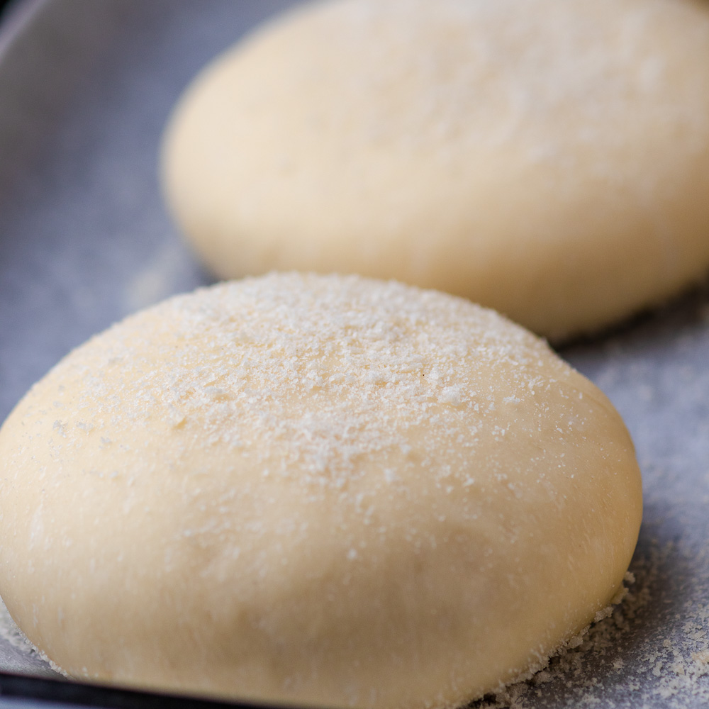 an image of vegan english muffins dough on a baking sheet