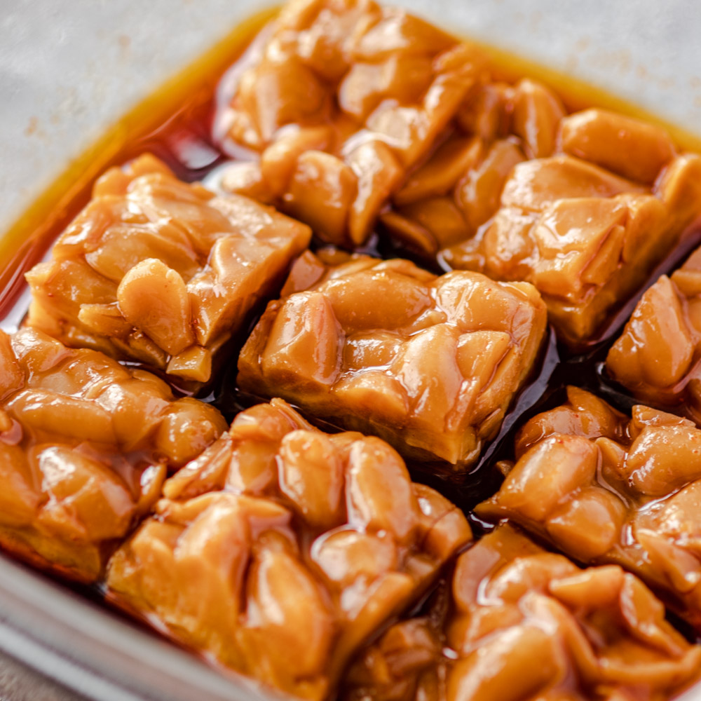 an image of tempeh marinating in sauce