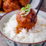 an image of Japanese-style meatballs with sticky sauce over rice