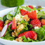 green salad with strawberries, walnuts and radishes