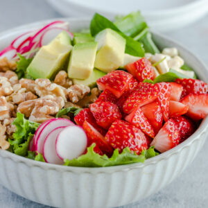 spring salad with strawberries, walnuts, radishes, avocado
