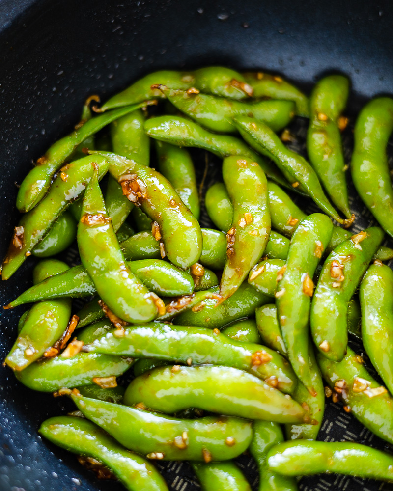an image of spicy garlic edamame in a pan