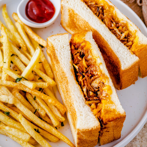 an image of vegan pulled pork sandwich with french fries