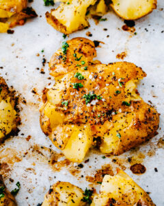 an image of smashed lemon garlic potatoes