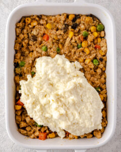 an image of mashed potatoes topped tempeh filling for vegan shepherds pie