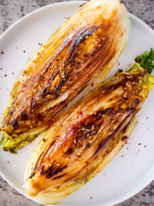 an image of napa cabbage steaks on a white plate