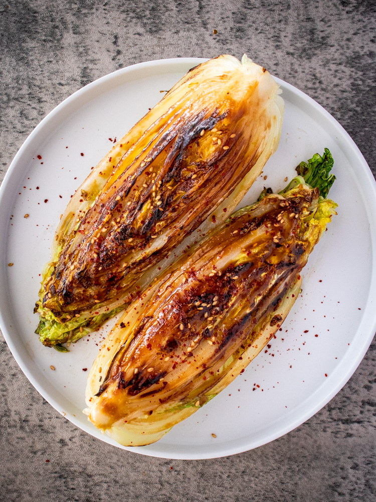 an image of napa cabbage steaks on a white plate