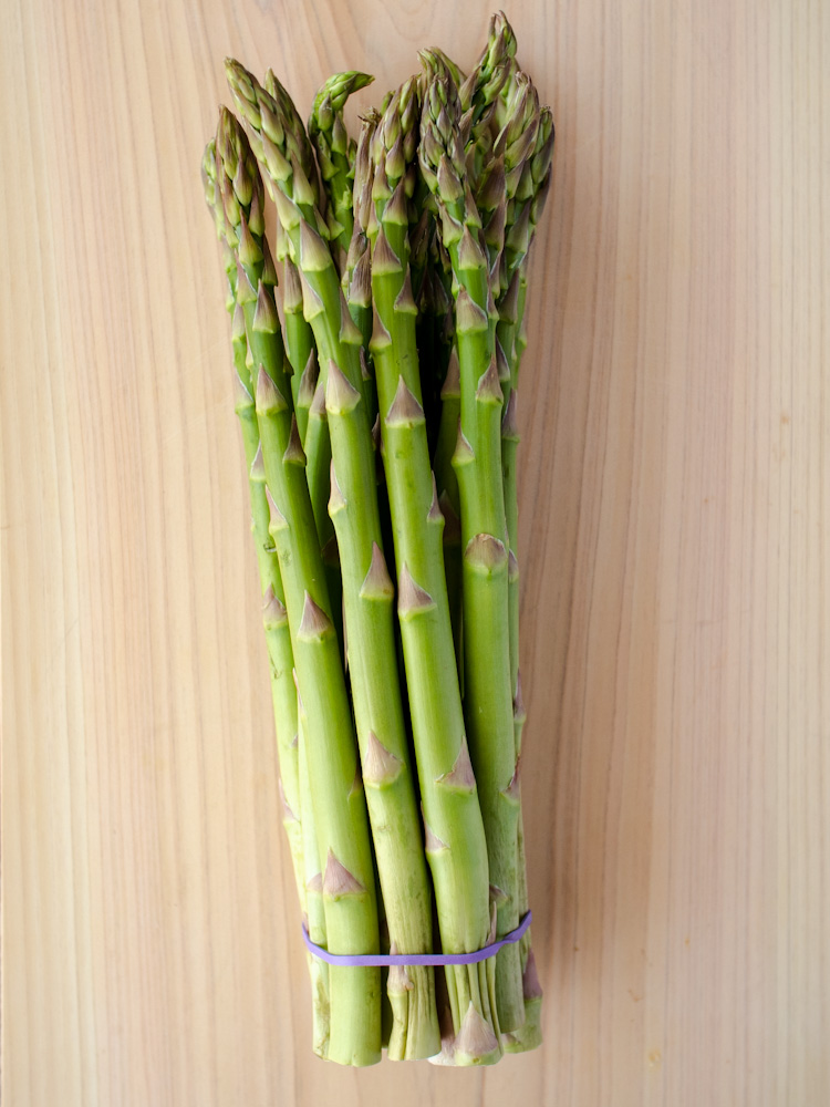 an image of a bunch of asparagus on a wooden cutting board