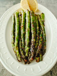 an image of miso butter asparagus on a white plate