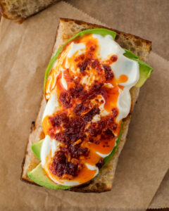 an image of whipped tofu on toast with avocado and chili crisp