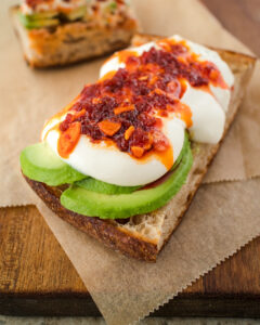 an image of whipped tofu on toast with avocado and chili crisp
